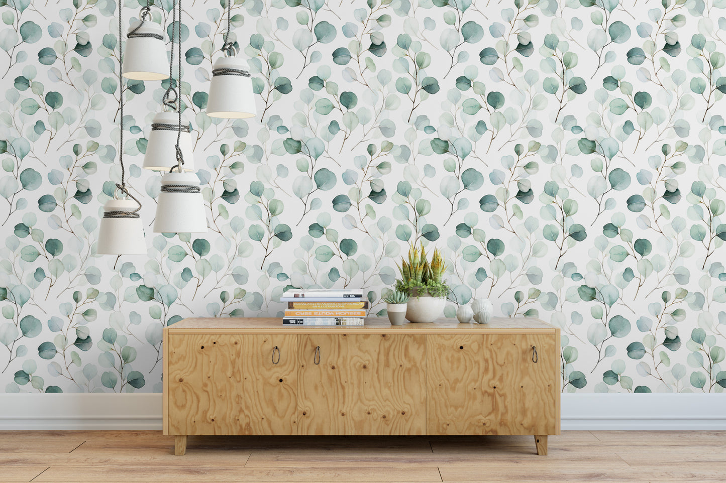 a wooden cabinet with a stack of books on top, set against a wall with a green leaf pattern wallpaper.