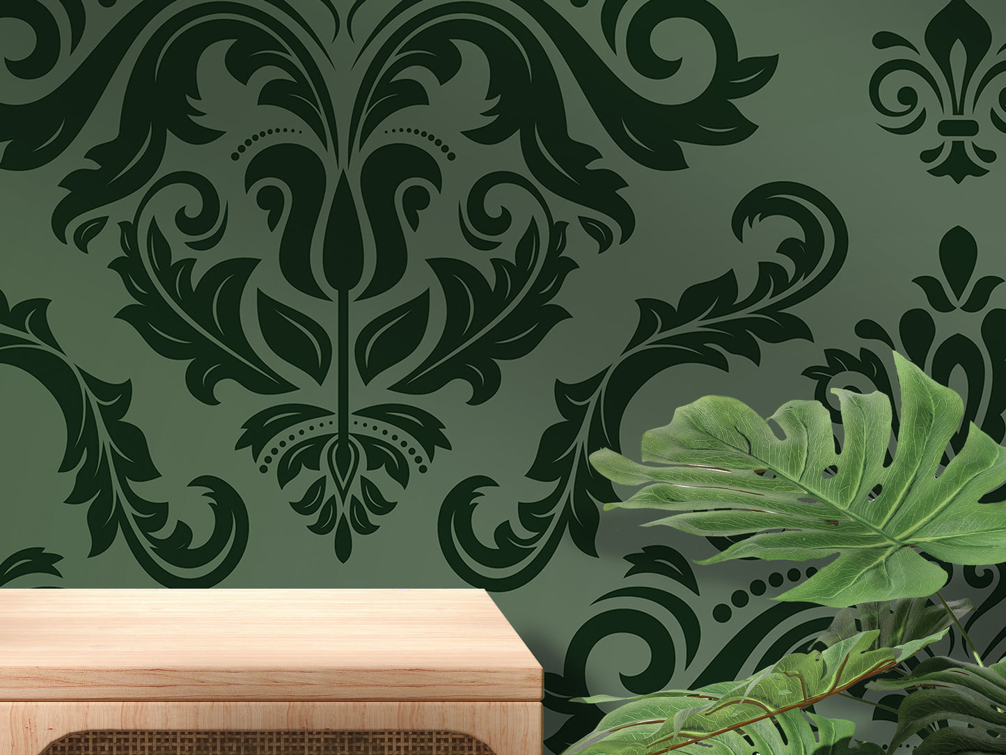 a dark green wall with a floral pattern, a wooden table, and a large green leaf plant.