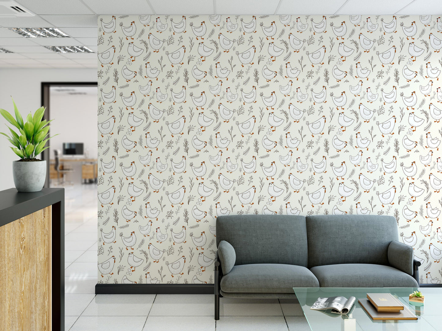 a modern office space with a gray sofa, a glass coffee table, and a wall with a repeating pattern of white and orange birds.