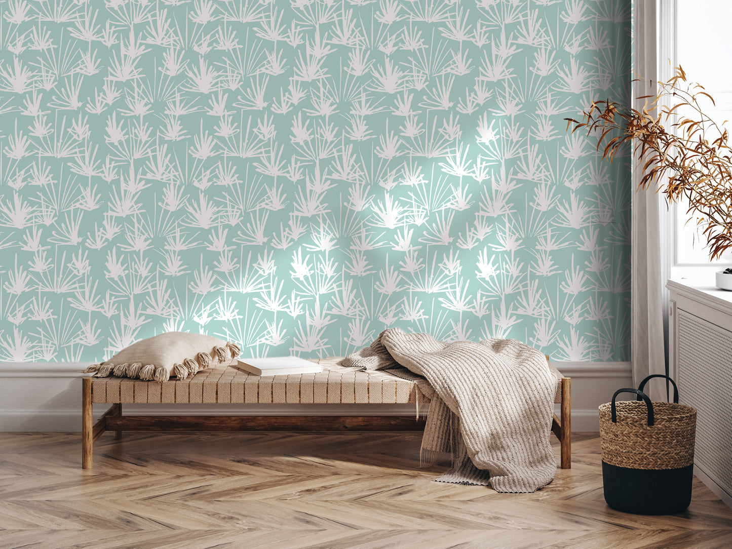 a modern living room with a wooden floor and a light-colored bench against a wall with a patterned wallpaper. The bench is adorned with a throw blanket and a woven basket, adding a cozy touch to the space.