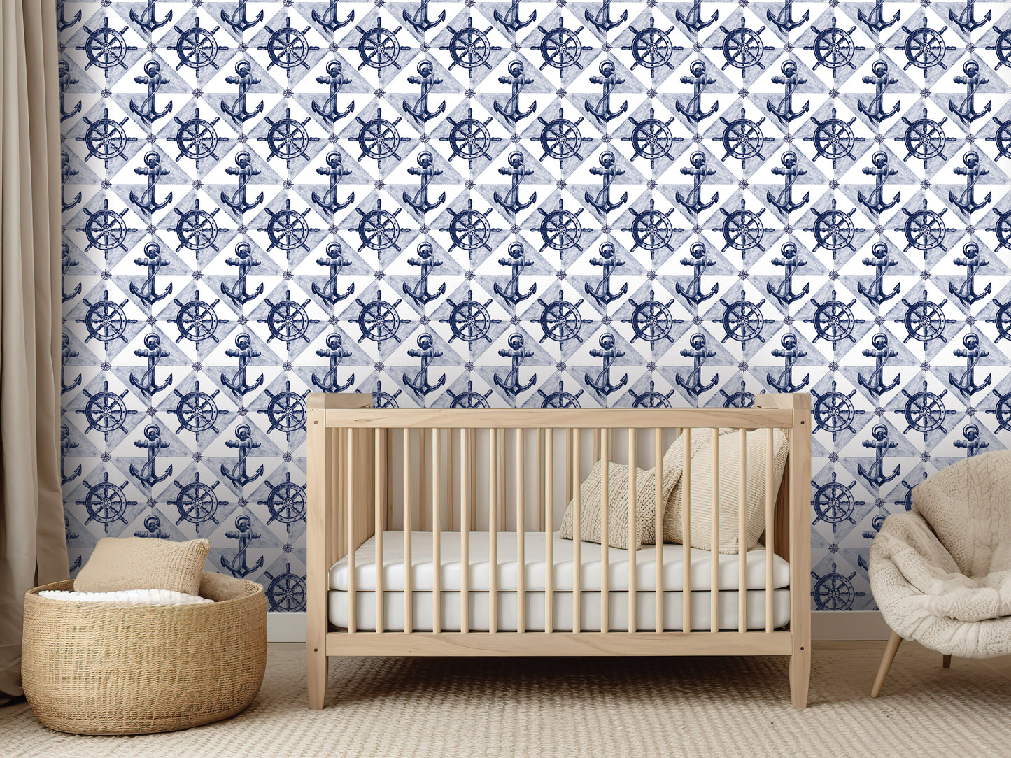 a nursery room with a wooden crib, a beige chair, and a woven basket. The walls of the room are decorated with a repeating pattern of blue anchors and white sails, creating a nautical theme.