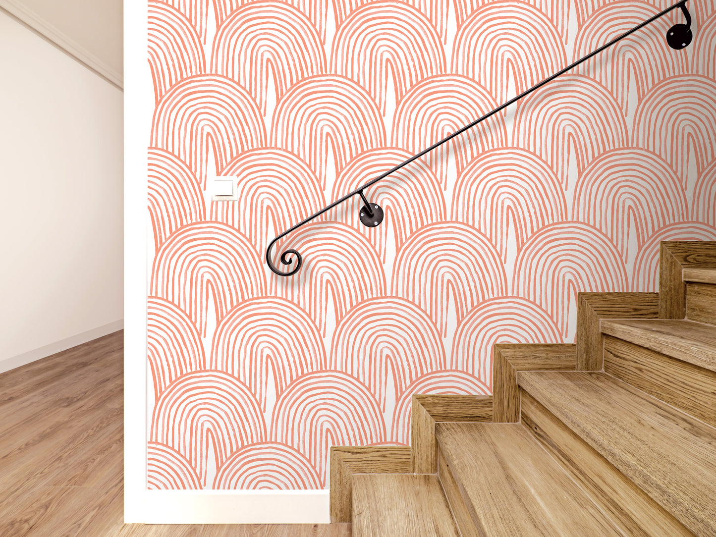 a staircase with wooden steps and a black metal handrail. The wall behind the staircase has a repeating pattern of orange and white circles, creating a visually striking design.