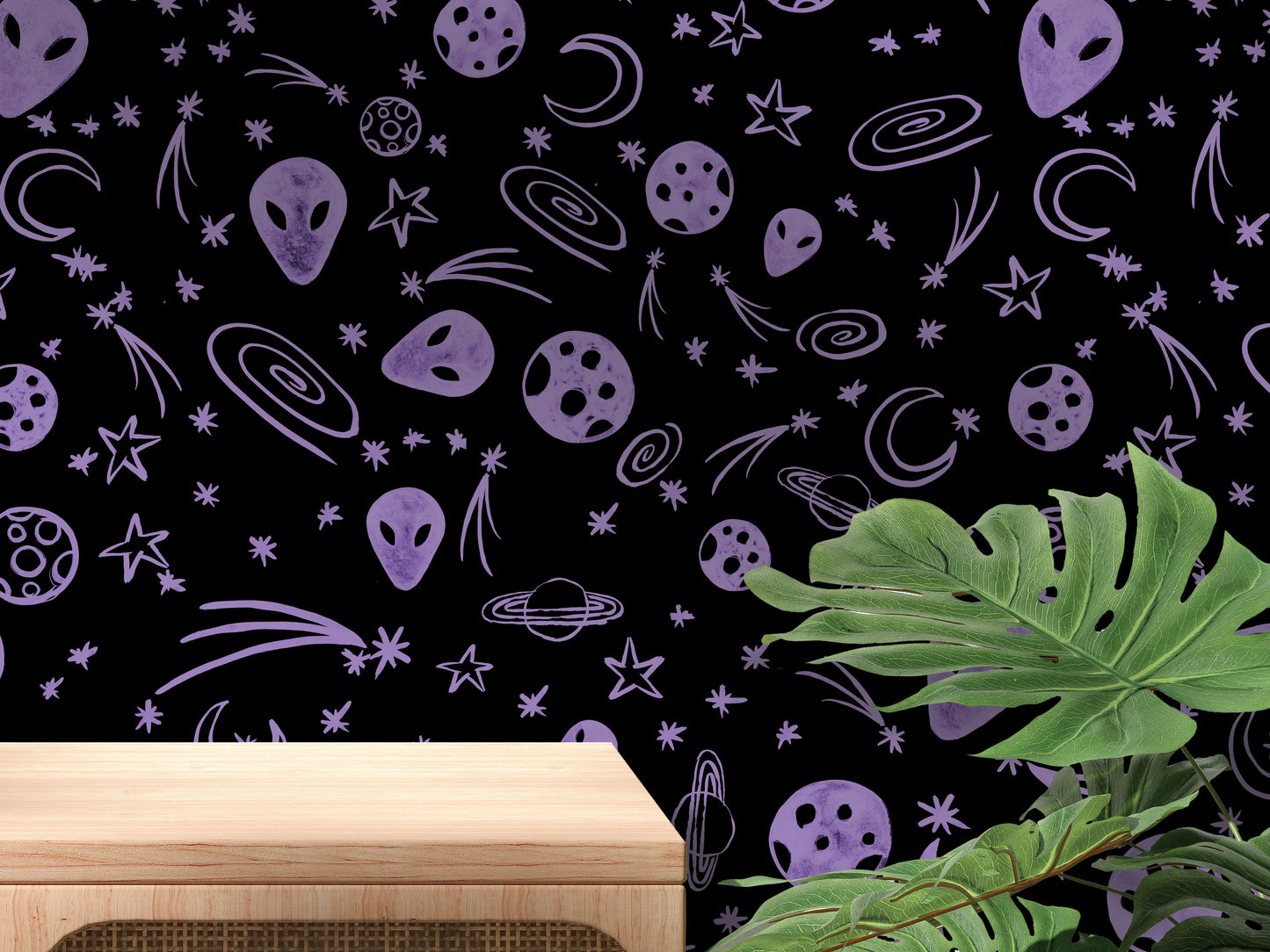 a wall with a black background adorned with various celestial objects, including planets, stars, and comets, as well as a wooden table in the foreground.
