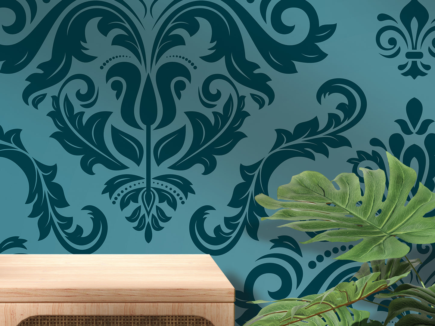 a blue wall with a decorative floral pattern, a wooden table, and a plant with large green leaves.