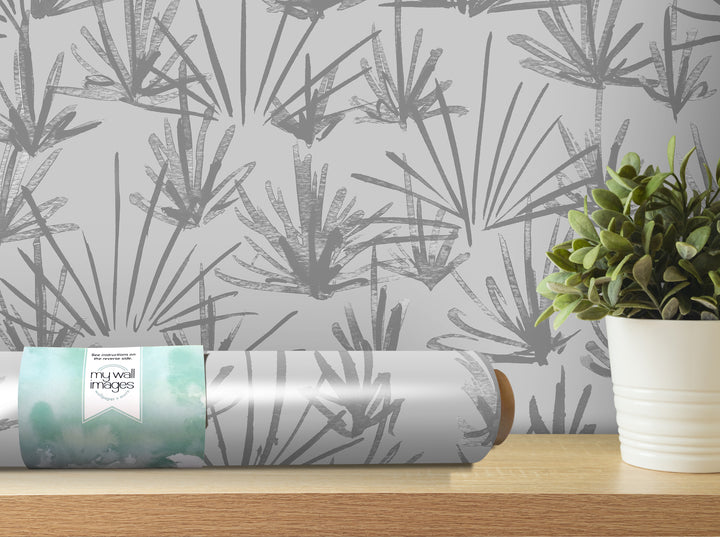 a gray and white patterned wallpaper with a potted plant on a shelf next to it.