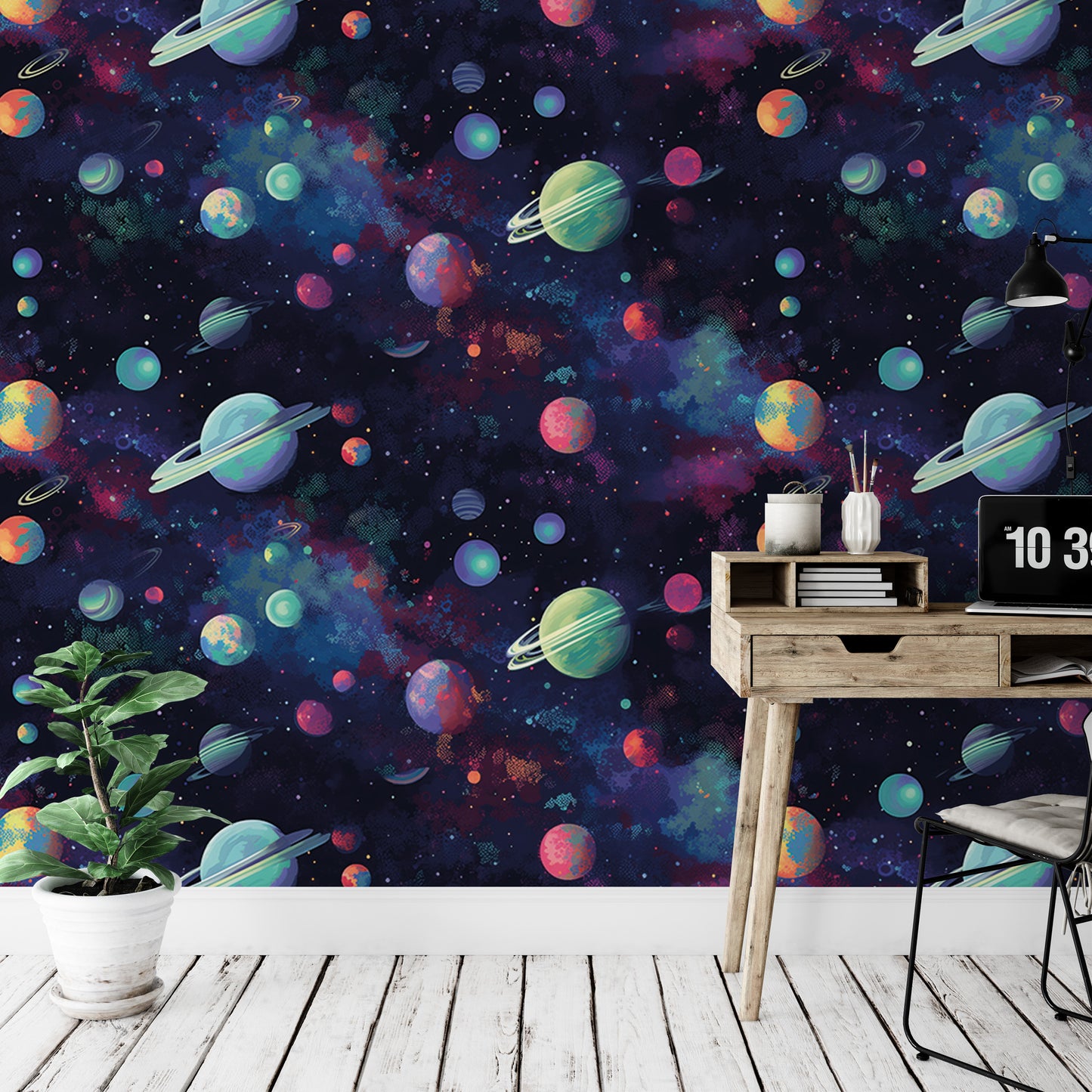 a wallpapered wall with a space-themed design, including planets, stars, and other celestial objects. There is a wooden desk with a laptop and a plant in the foreground, and a chair is visible in the background.