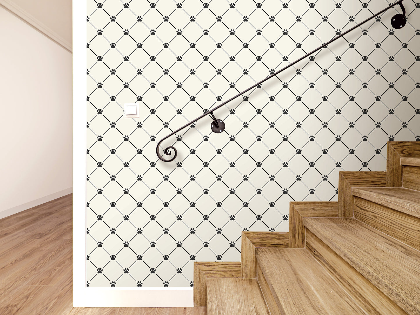 a staircase with a black metal handrail, set against a wall with a repeating diamond pattern of black paw prints.