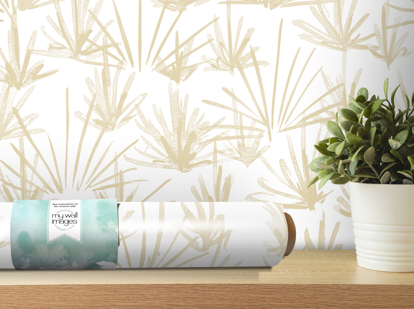 a roll of wallpaper with a floral pattern, placed on a shelf next to a potted plant.