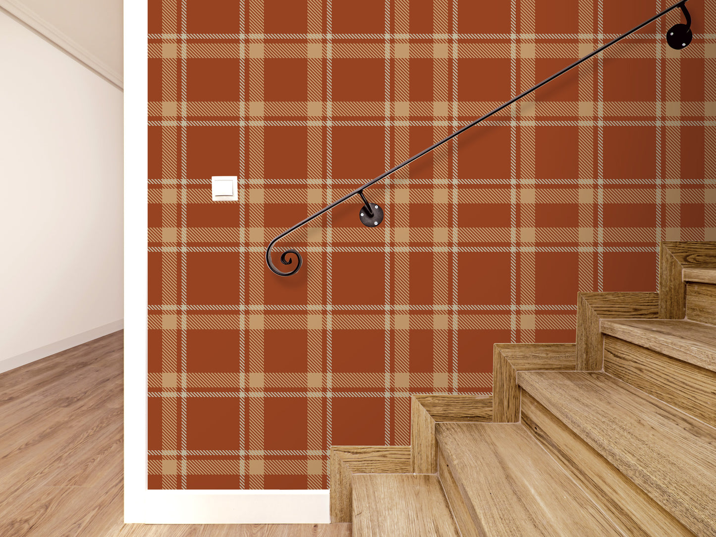 a wooden staircase with a black metal handrail, set against a wall with a red and orange plaid pattern.