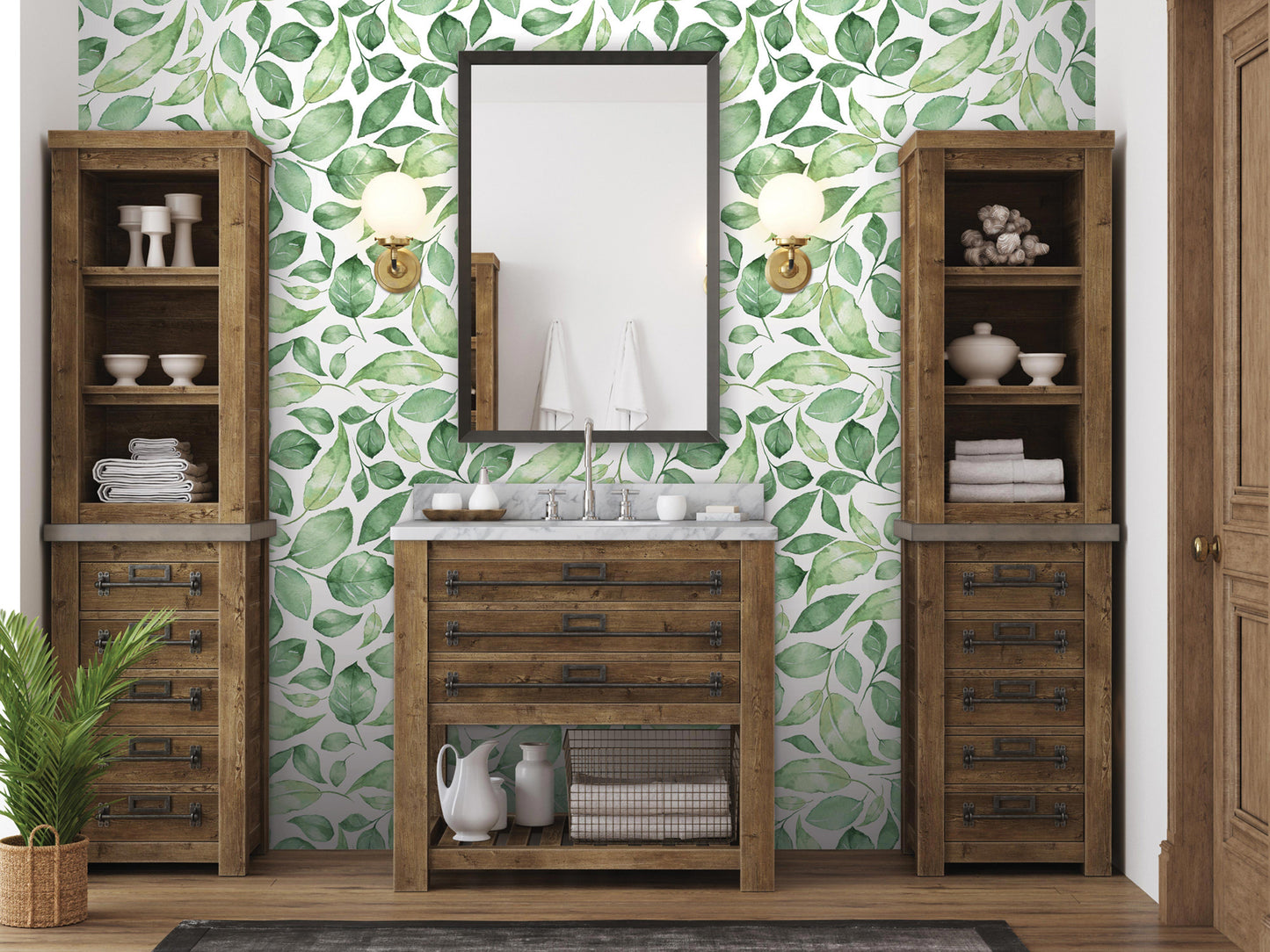 a bathroom with a wooden vanity, a mirror, and a green leaf-patterned wallpaper. The room has two wooden cabinets and a potted plant, creating a cozy and natural atmosphere.