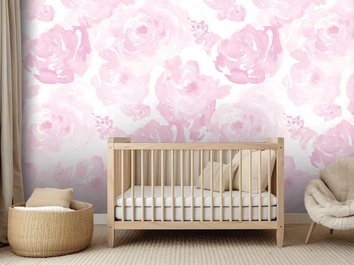 a nursery room with a wooden crib, a woven basket, and a plush chair. The walls are covered in a pink floral wallpaper, creating a soft and soothing atmosphere.