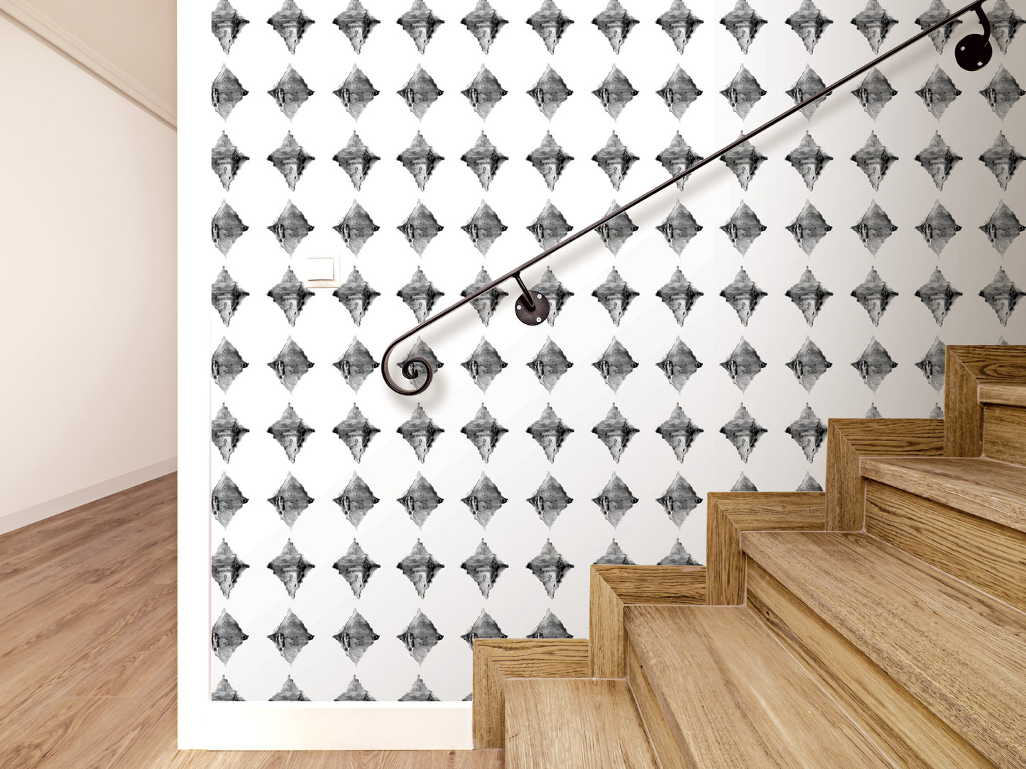a staircase with a black metal handrail, and the wall behind it has a repeating diamond pattern.