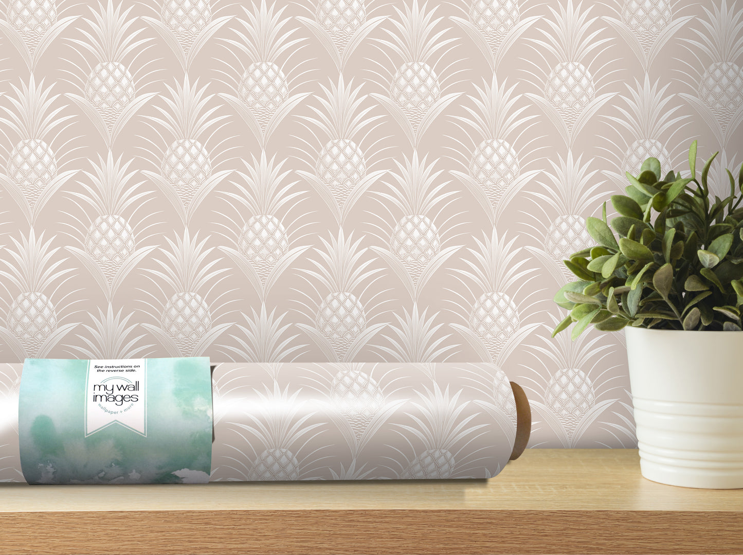 a roll of wallpaper with a repeating pineapple pattern, placed on a wooden shelf next to a potted plant.