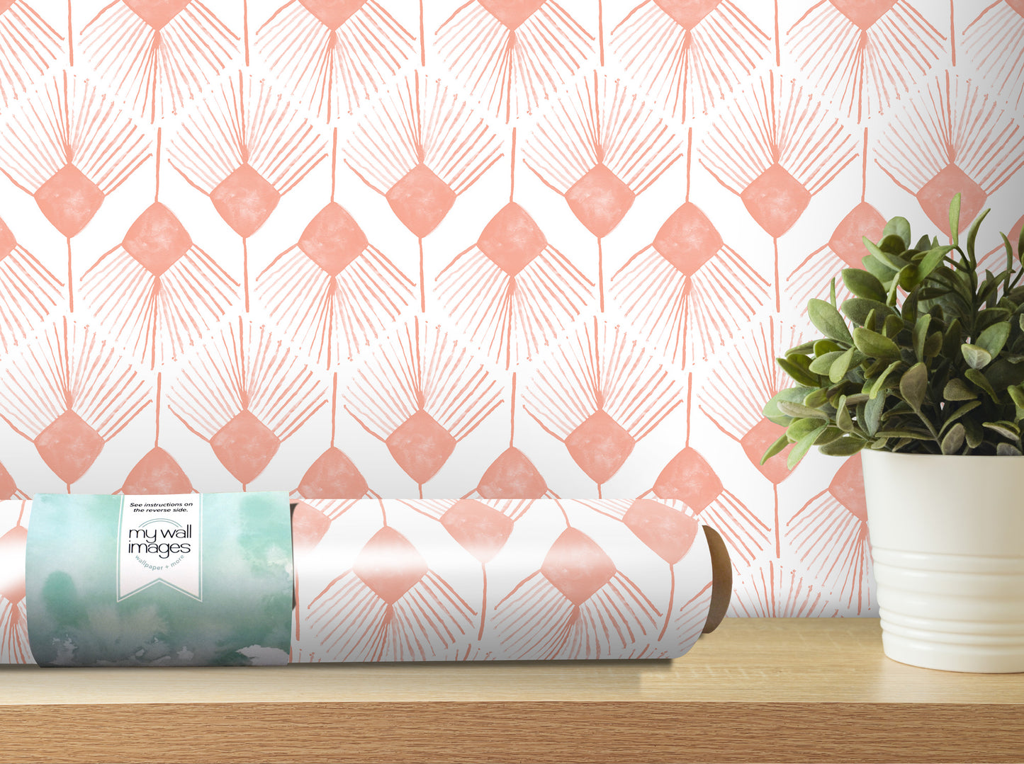 a wall with a patterned wallpaper, a potted plant, and a roll of wallpaper on a shelf.