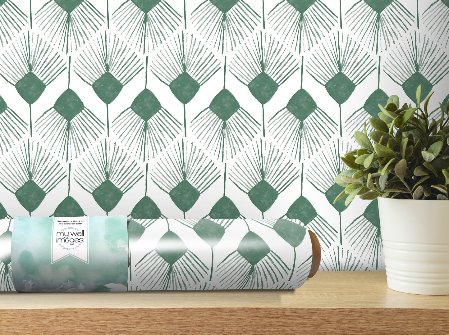 a roll of wallpaper with a repeating pattern of green and white diamond shapes, placed on a wooden shelf next to a potted plant.