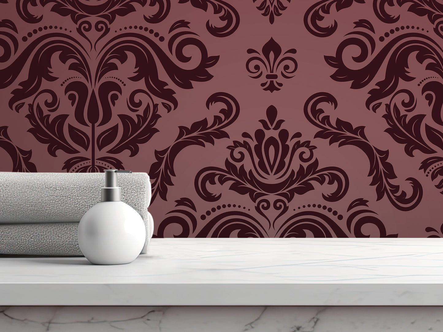 a white marble countertop with a white soap dispenser and a folded gray towel. The backdrop is a rich burgundy damask pattern with intricate floral designs.
