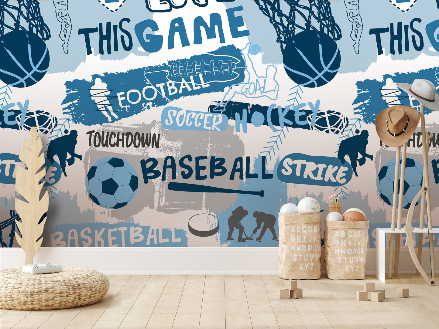 a wallpapered wall with various sports-related words and illustrations, including "TOUCHDOWN", "BASEBALL", "SOCcer", "HOCKEY", "BASKETBALL", and "STRIKE". There are also some wooden objects, such as a hat rack and a basket, placed in front of the wall.