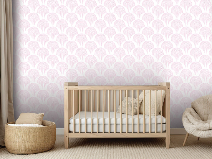a nursery room with a wooden crib, a woven basket, and a plush chair. The walls are decorated with a repeating pattern of pink and white circles, creating a soothing and calming atmosphere.