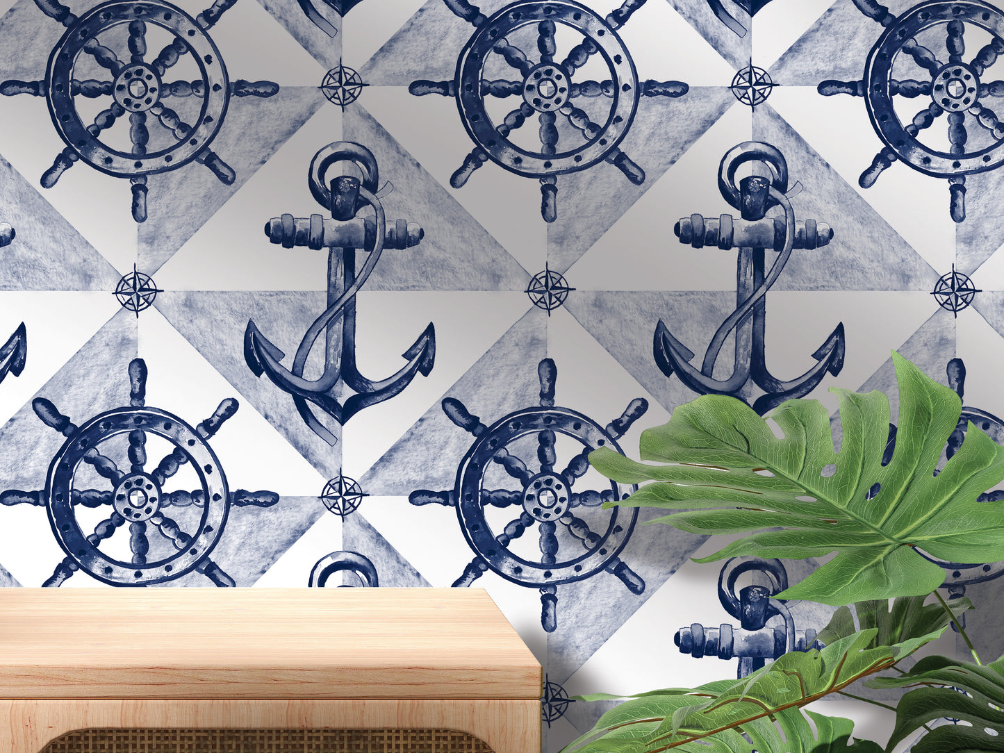 a wallpapered wall with a repeating pattern of blue and white nautical-themed elements, including ship's sails, anchors, and steering wheels. In the foreground, there is a wooden table and a plant, creating a nautical-inspired interior design.