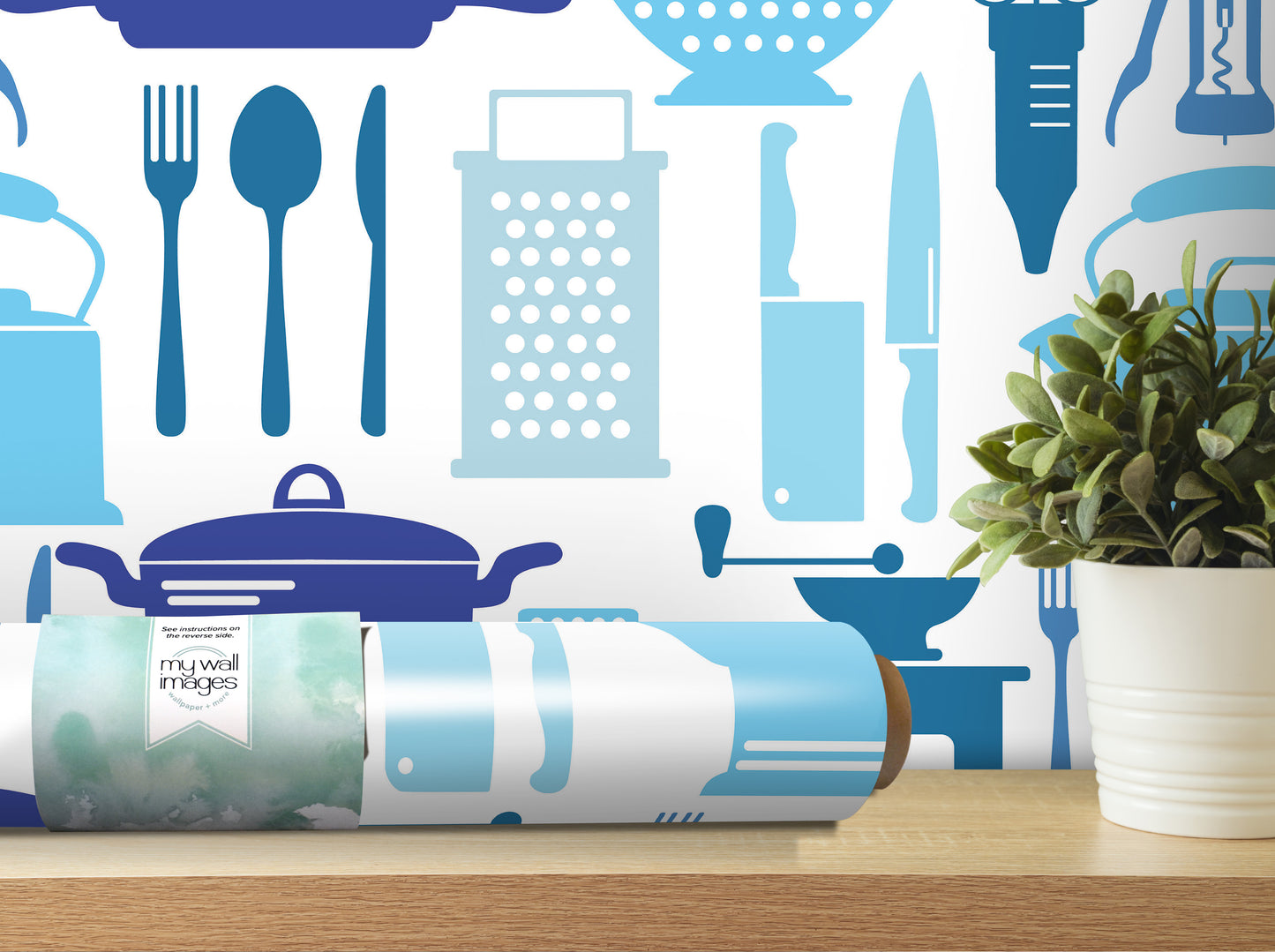 a kitchen-themed wallpaper with various kitchen utensils and appliances, such as a knife, a spoon, a grater, and a pot, all depicted in blue and white colors. In addition to the kitchen-themed wallpaper, there is a potted plant and a roll of wallpaper on a shelf, creating a cozy and inviting atmosphere in the room.