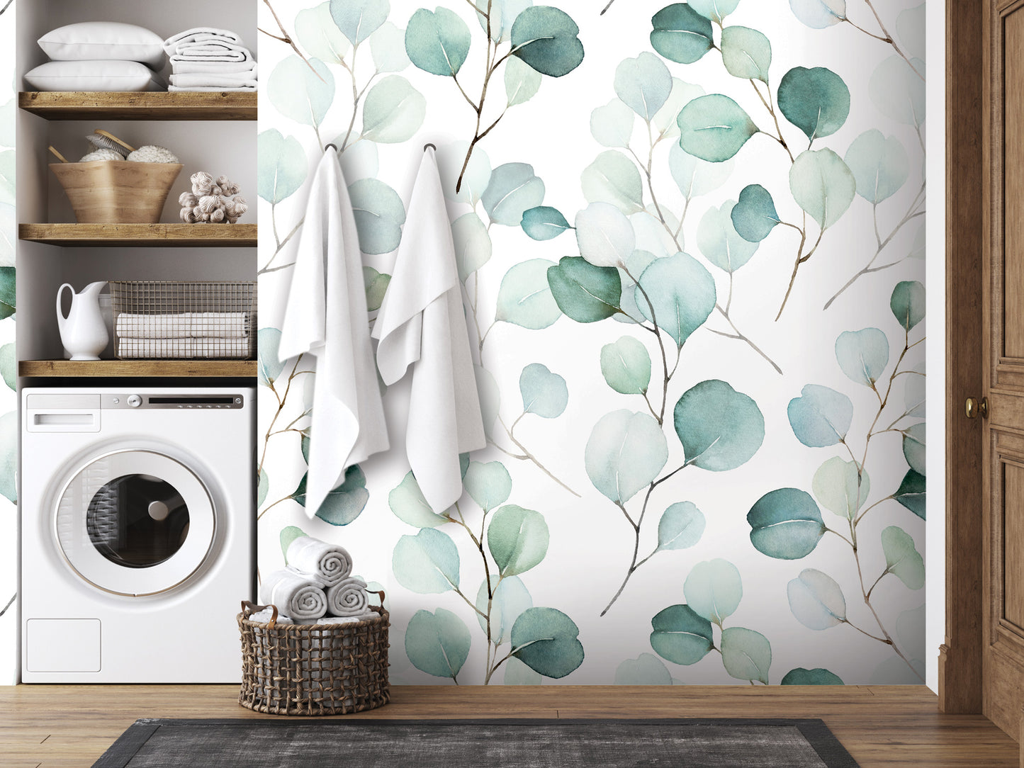 a bathroom with a white washing machine, a wooden shelf with towels and baskets, and a wallpapered wall with a green leaf pattern.