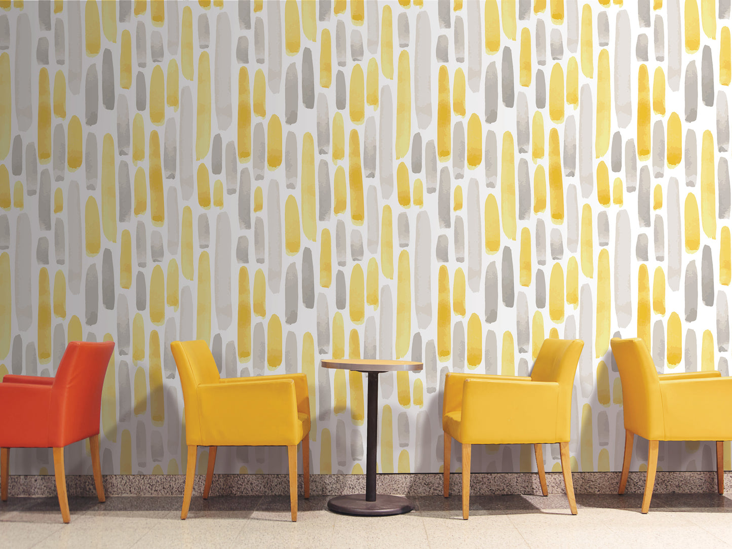 a modern and stylish interior design with a wallpapered wall in shades of yellow and gray, complemented by four yellow chairs arranged around a small round table.
