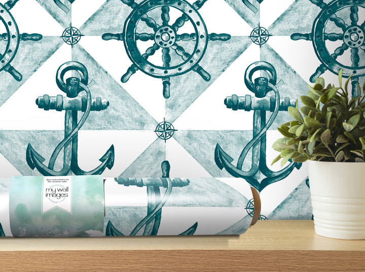 a wallpapered wall with a repeating pattern of anchors and a ship's wheel, along with a potted plant and a roll of wallpaper on a shelf.