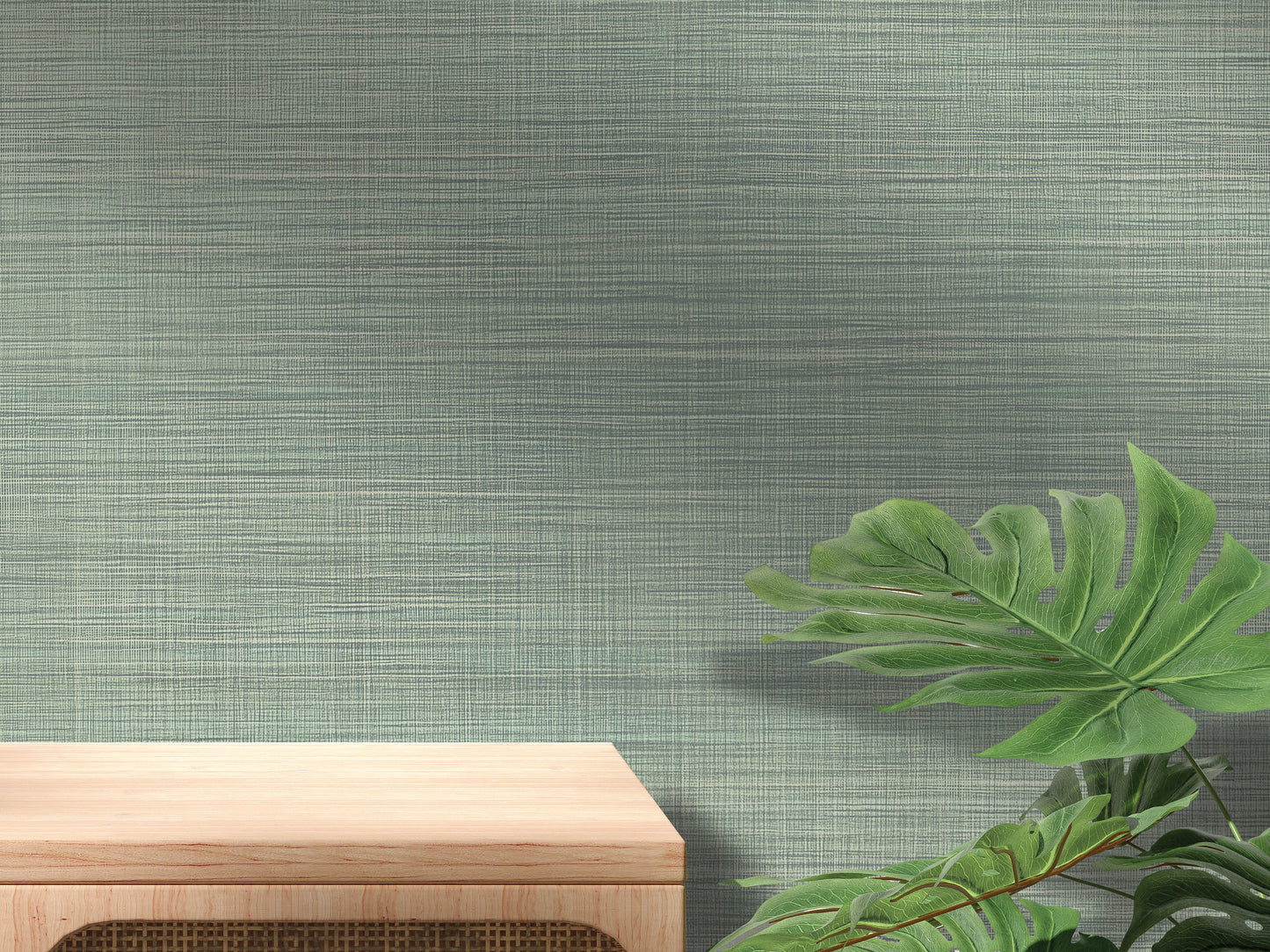 a wooden table with a plant on the right side, set against a textured green wall.