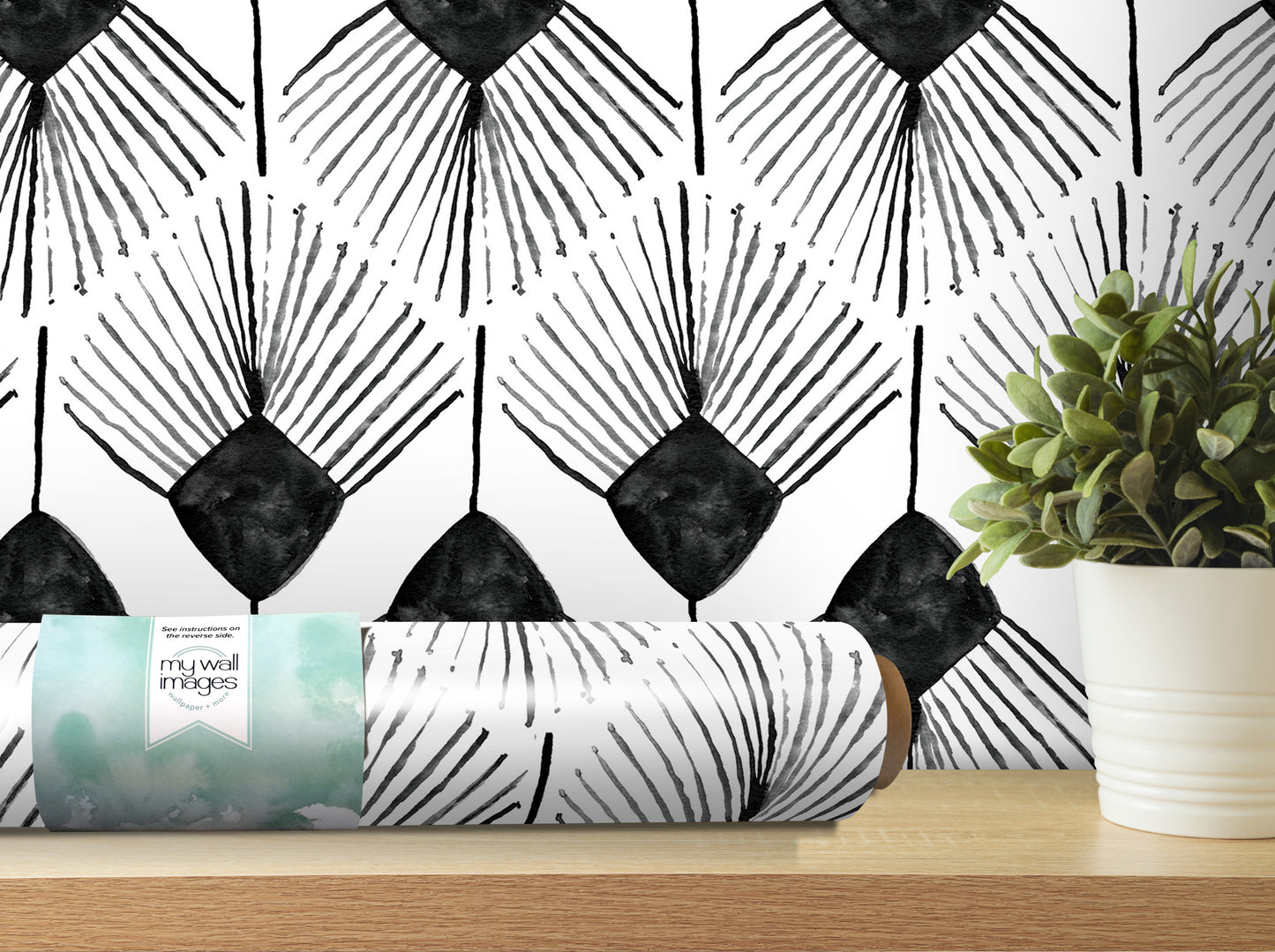 a black and white geometric pattern wallpaper with a potted plant on a shelf in the foreground.