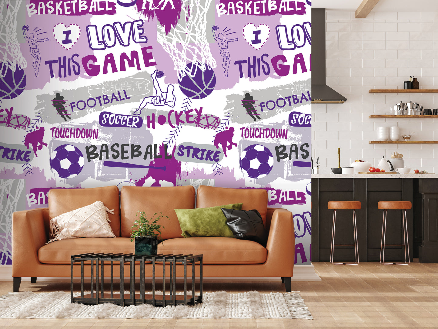 a living room with a brown leather couch, a coffee table, and a kitchen area with a counter and stools. The wall behind the couch is covered in a vibrant, colorful collage of sports-related words and images, including basketball, soccer, hockey, and football.
