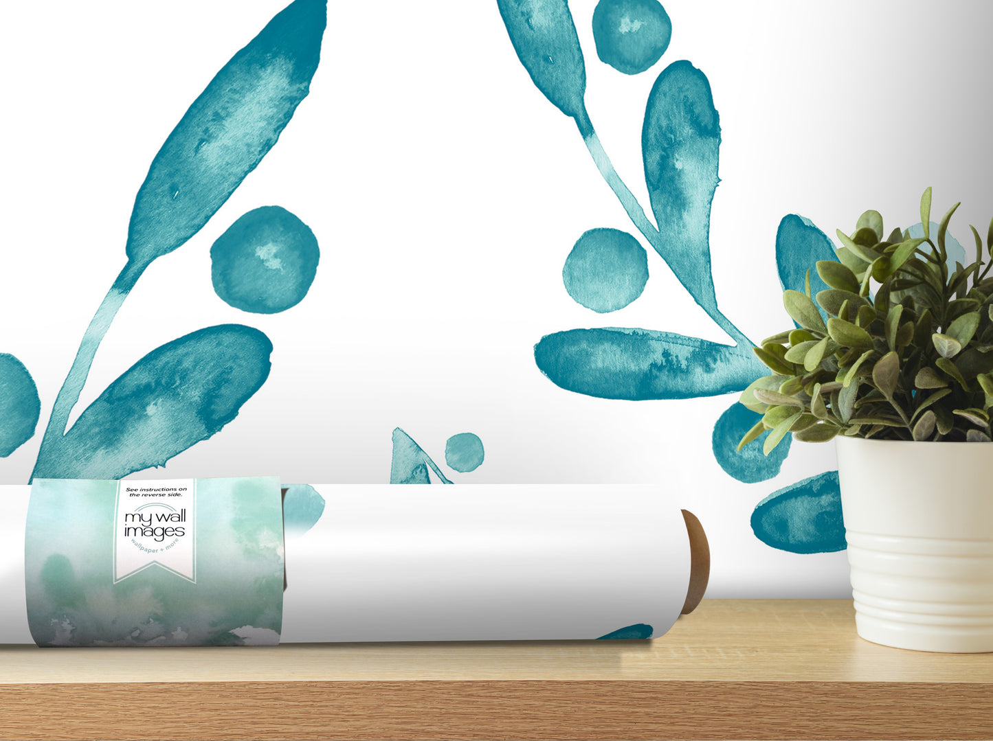 a white wall with a large blue leaf-like design and a potted plant on a wooden shelf.