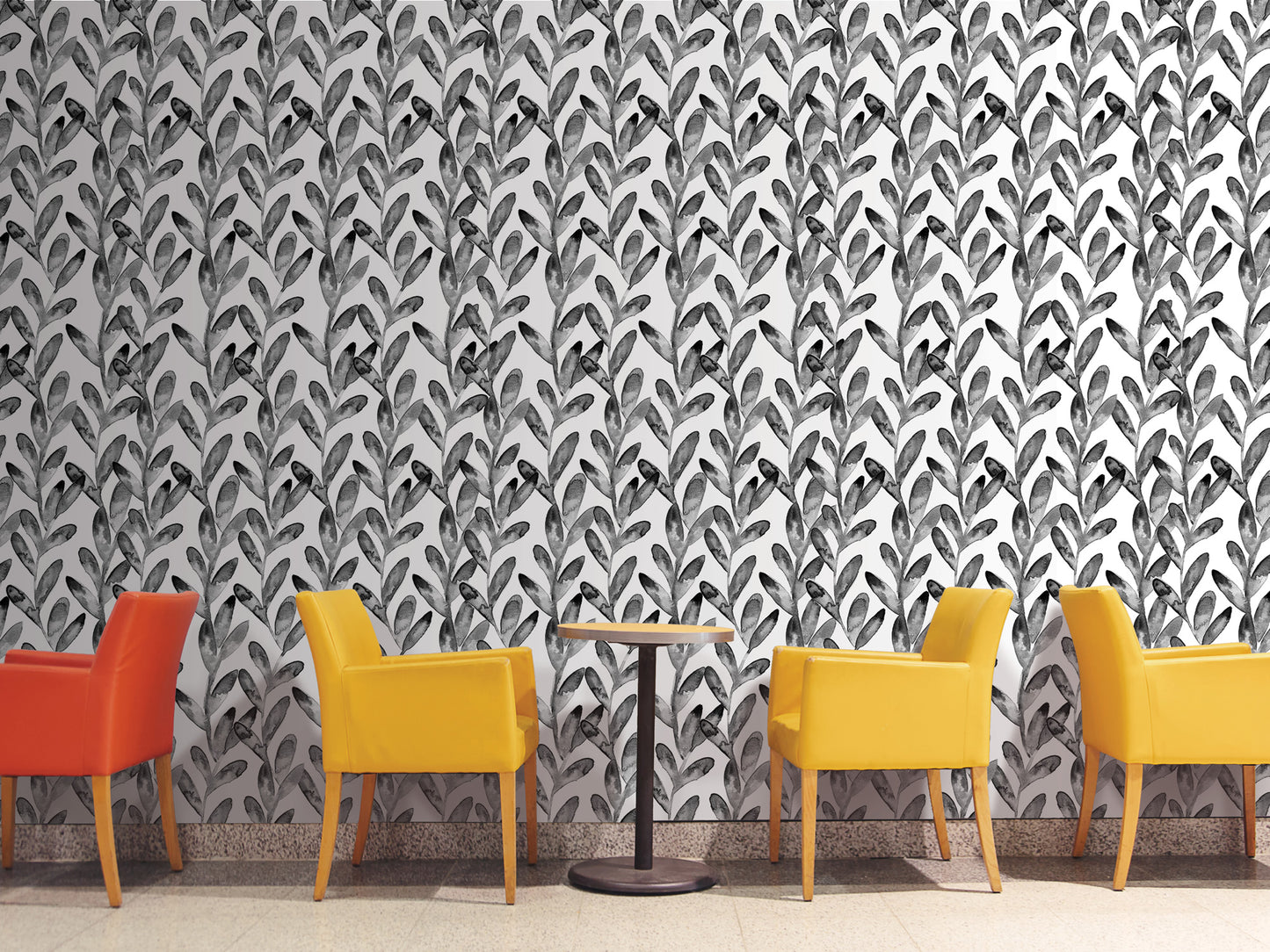 a modern and stylish interior design with a black and white leaf pattern wallpaper covering the wall behind a row of four yellow chairs and a small round table.