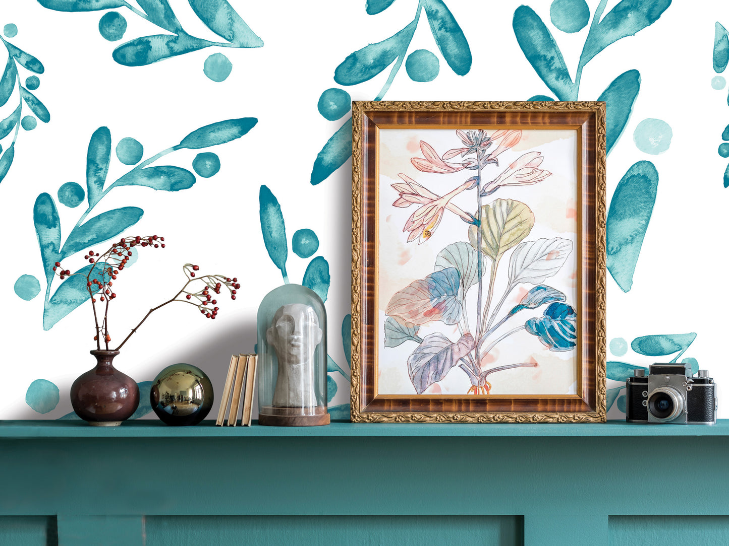 a shelf with various decorative items, including a framed botanical drawing, a vase with flowers, a glass dome, and a camera. The shelf has a teal color, and the background is a white wall with a watercolor-style floral pattern.