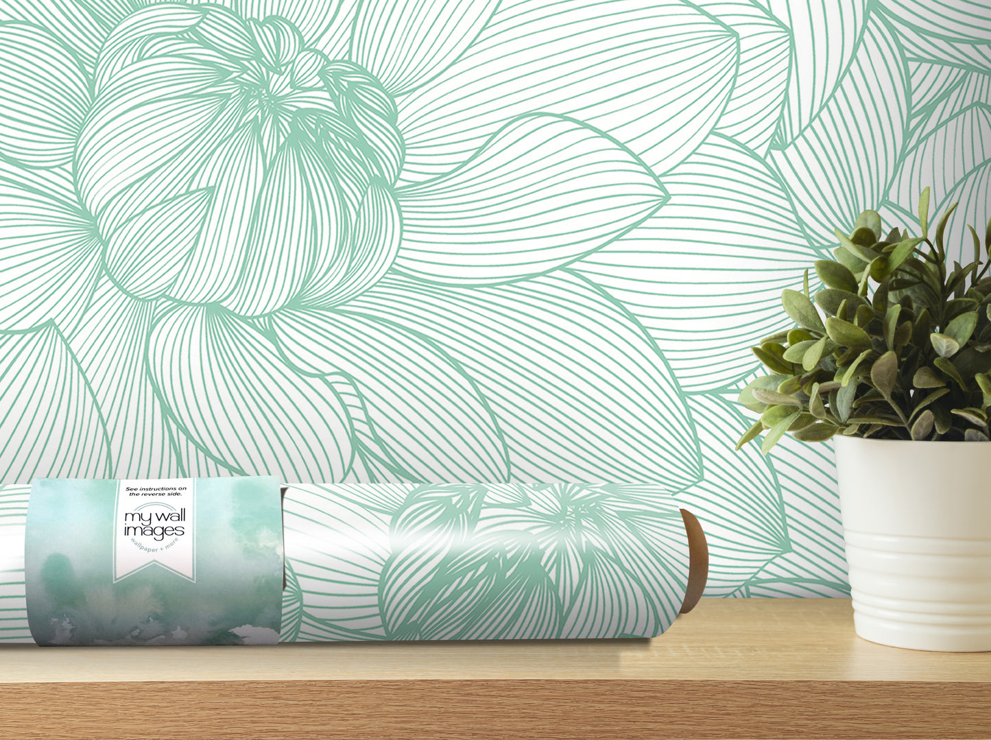 a wallpapered wall with a large green flower design, a roll of wallpaper, and a potted plant on a shelf.