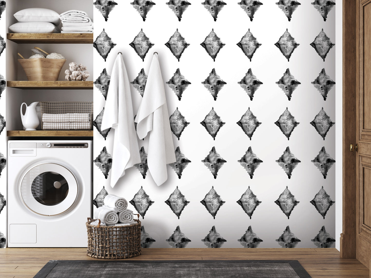 a bathroom with a white washing machine, a basket of towels, and a patterned wall with a repeating diamond design.