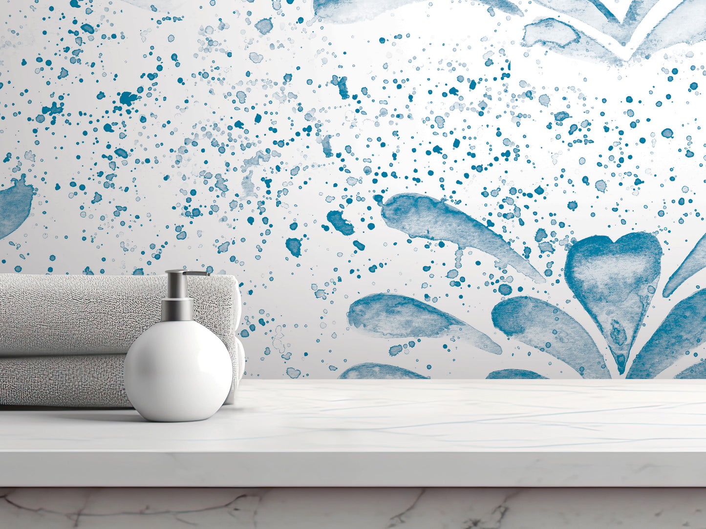 a white countertop with a white soap dispenser and a gray towel. The backdrop is a white wall with a blue watercolor-style design.
