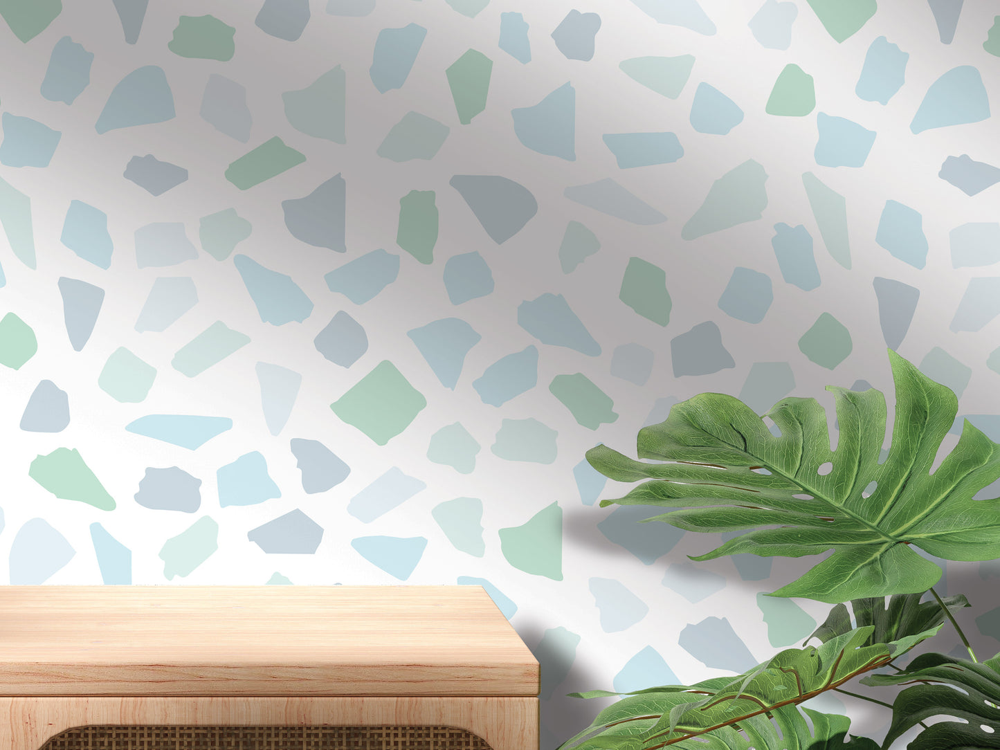 a wooden table with a plant on top of it, set against a wall with a pattern of small, colorful tiles or stones.