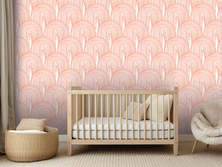 a nursery room with a wooden crib, a woven basket, and a plush chair. The walls are decorated with a repeating pattern of orange and white circles, creating a warm and cozy atmosphere.