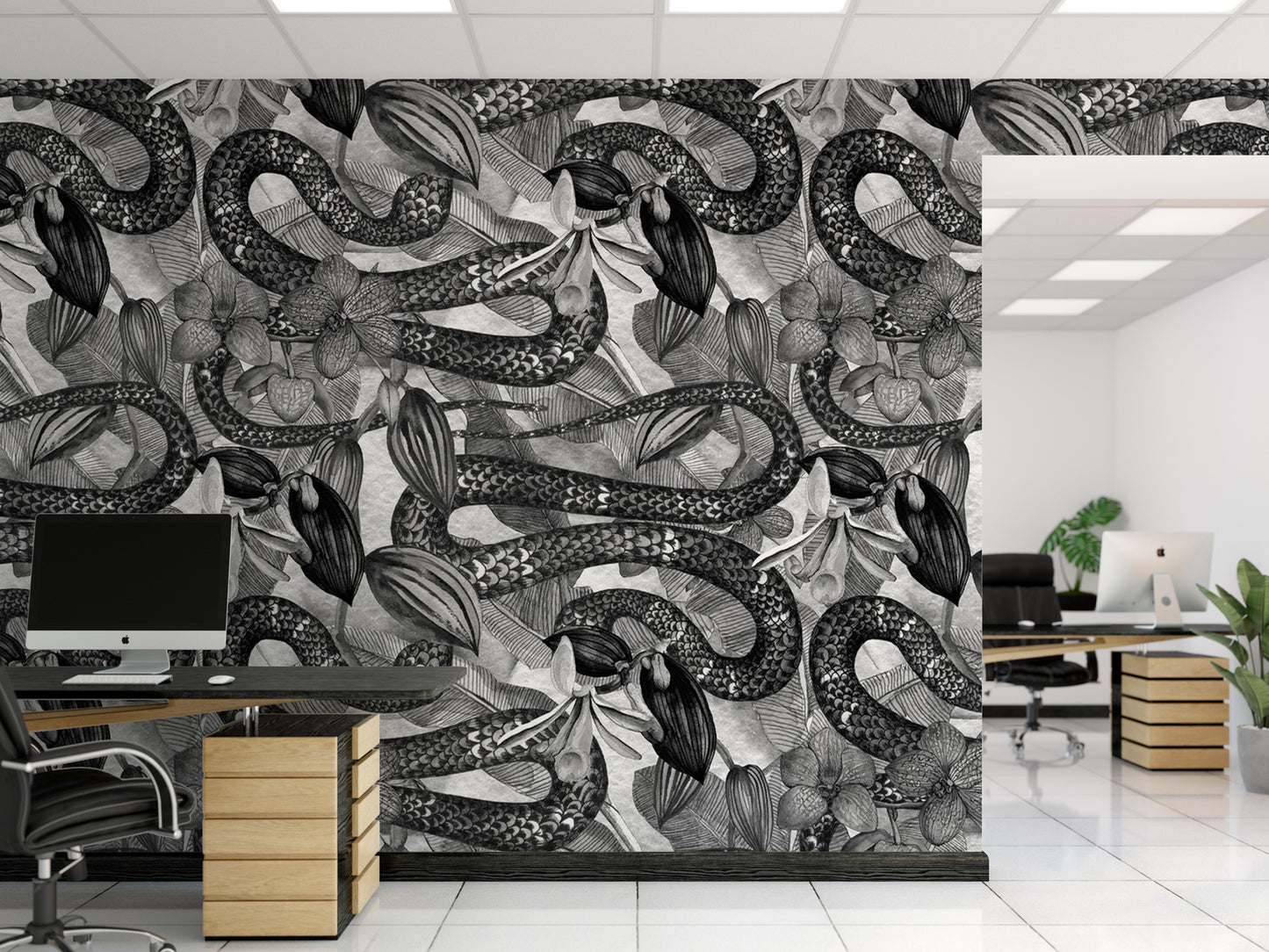 a modern office space with a large wall mural depicting a pattern of snakes and flowers in black and white. The office has a desk with a computer monitor, a chair, and a plant, creating a professional and visually appealing workspace.