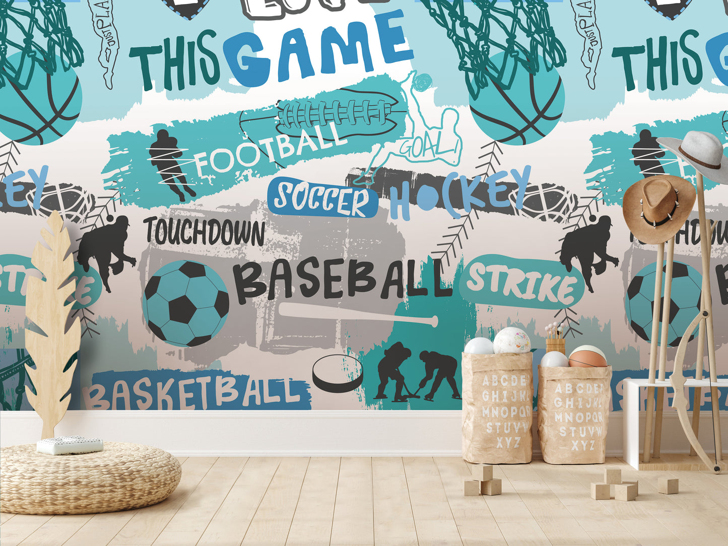 a wallpapered wall with various sports-related words and illustrations, including "TOUCHDOWN", "BASEBALL", "STRIKE", "SOCCER", "HOCKEY", and "BASKETBALL". There are also some sports equipment and accessories, such as a soccer ball, a baseball bat, and a wicker basket. The wallpapered wall is described as a collage of multiple images, and there are no specific details provided about the content of the collage.