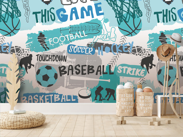 a wallpapered wall with various sports-related words and illustrations, including "TOUCHDOWN", "BASEBALL", "STRIKE", "SOCCER", "HOCKEY", and "BASKETBALL". There are also some sports equipment and accessories, such as a soccer ball, a baseball bat, and a wicker basket. The wallpapered wall is described as a collage of multiple images, and there are no specific details provided about the content of the collage.