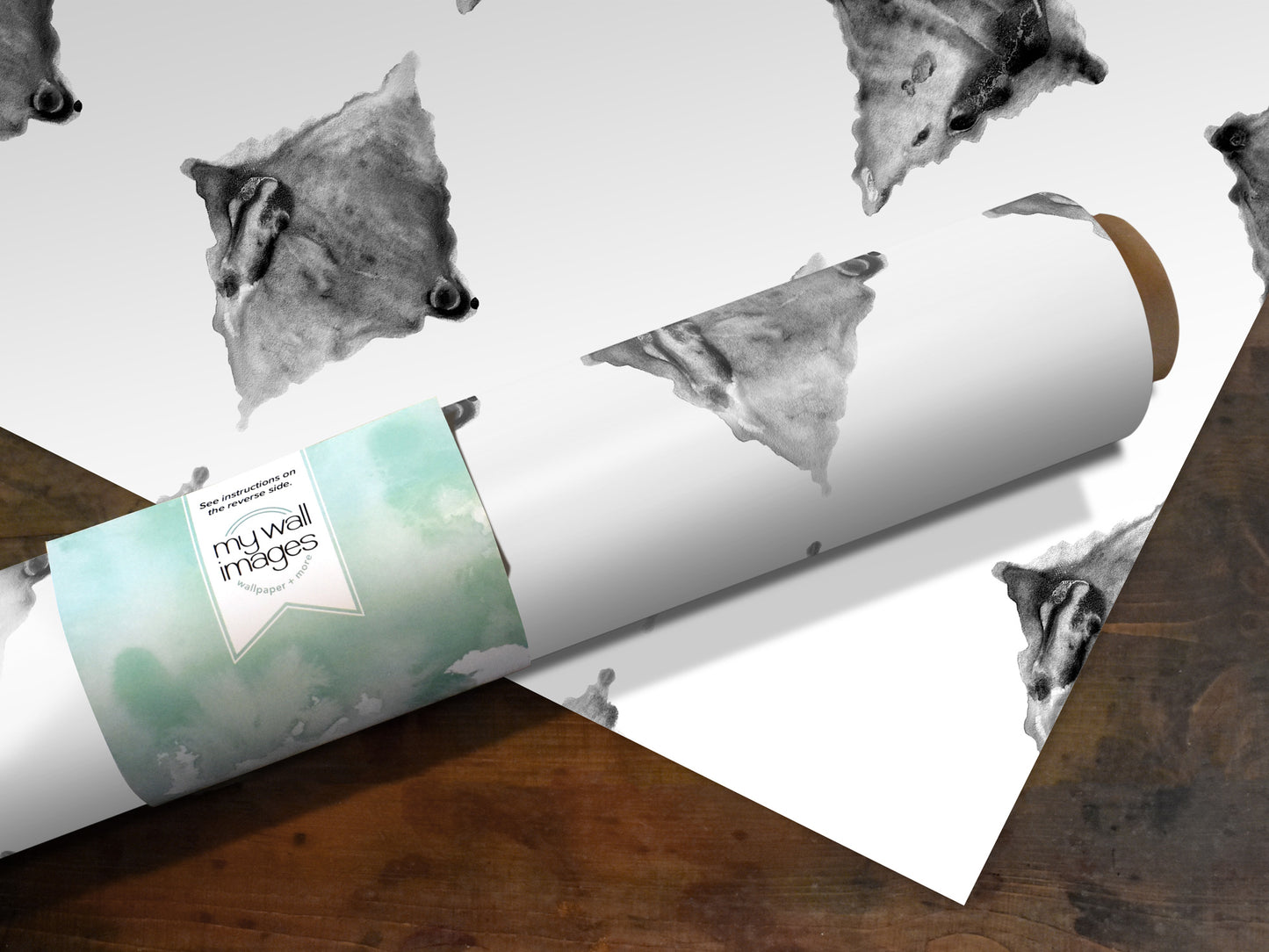 a roll of paper with a repeating pattern of black and white animal faces, including a bear, on it.