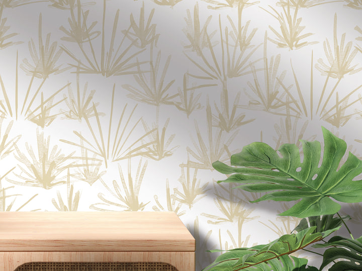 a wooden table with a plant on top of it, set against a wall with a repeating pattern of green leaves and branches.