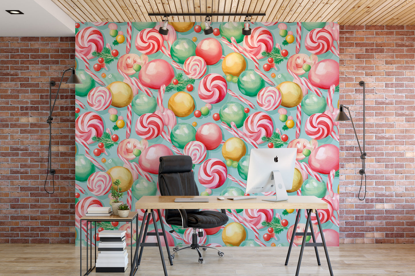 a modern office space with a large wall mural depicting colorful lollipops and candy. In the foreground, there is a desk with a computer monitor, a chair, and a plant.