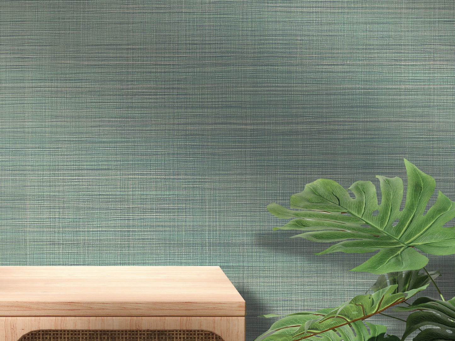 a wooden table with a plant on the right side, set against a textured green wall.