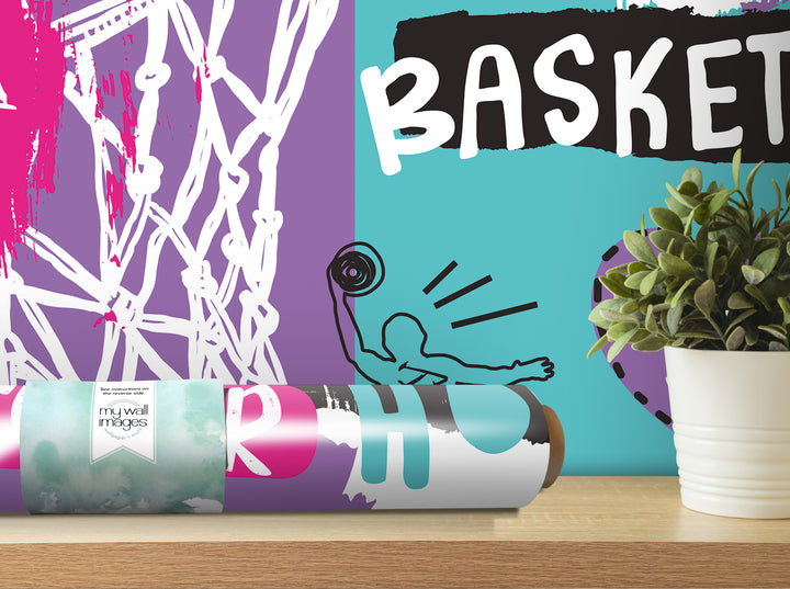 a colorful abstract wall decal with the word "BASKET" prominently displayed. In the foreground, there is a potted plant and a roll of wallpaper with a label that reads "my wall images".