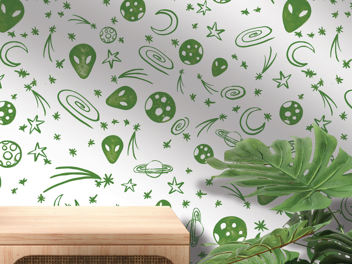 a wall with a repeating pattern of green alien and celestial motifs, including planets, stars, and comets, creating a whimsical and imaginative space-themed design.