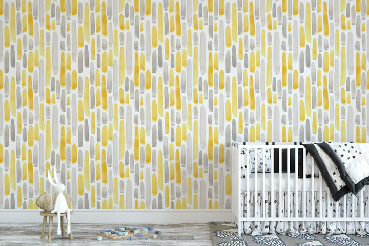 a nursery room with a white crib and a small white rabbit sitting on a wooden stool. The walls are covered in a patterned wallpaper with yellow and gray vertical lines.