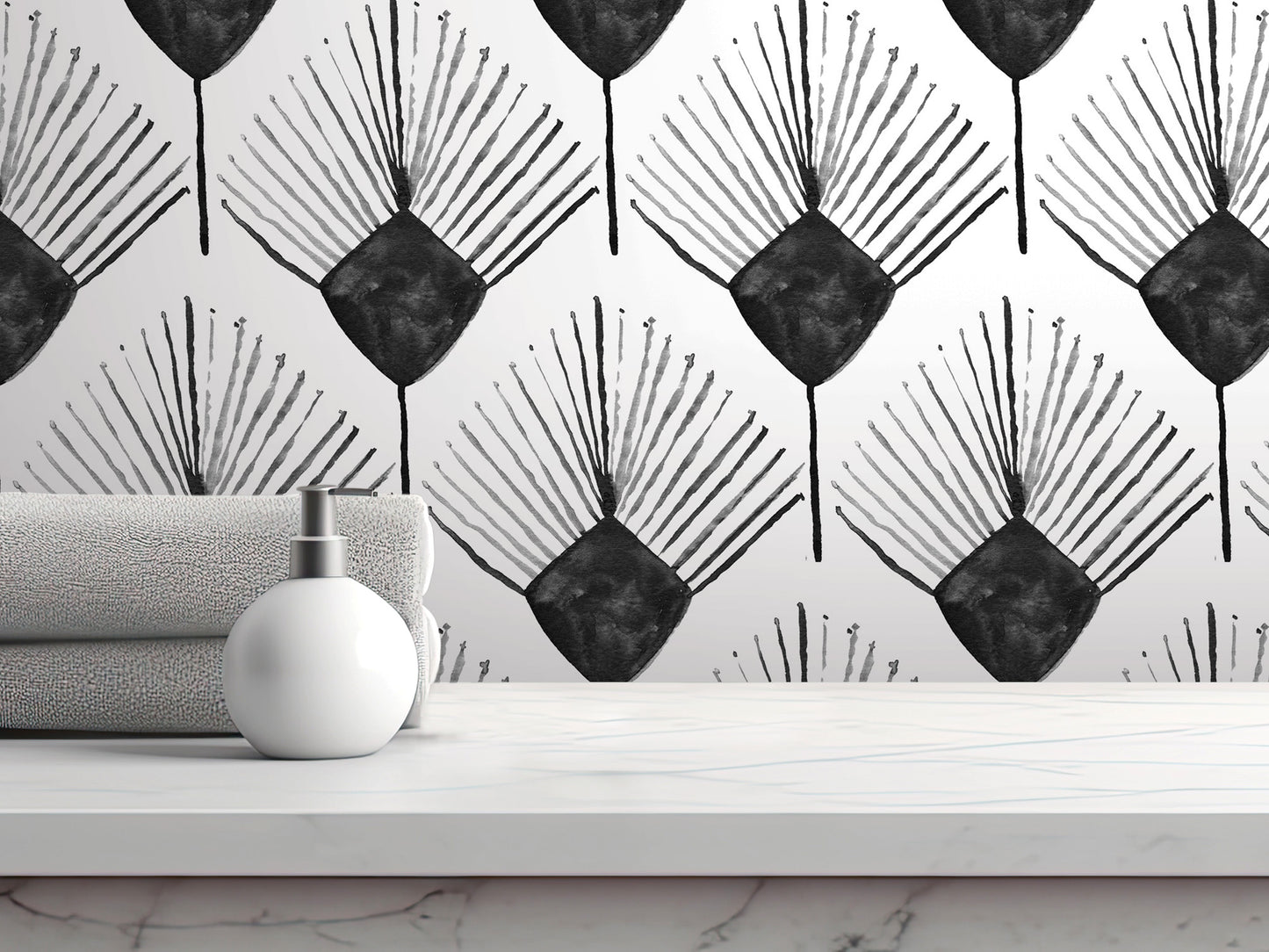a white marble countertop with a white soap dispenser and a folded gray towel. The countertop is set against a wall with a repeating black and white pattern of stylized leaves or flowers.