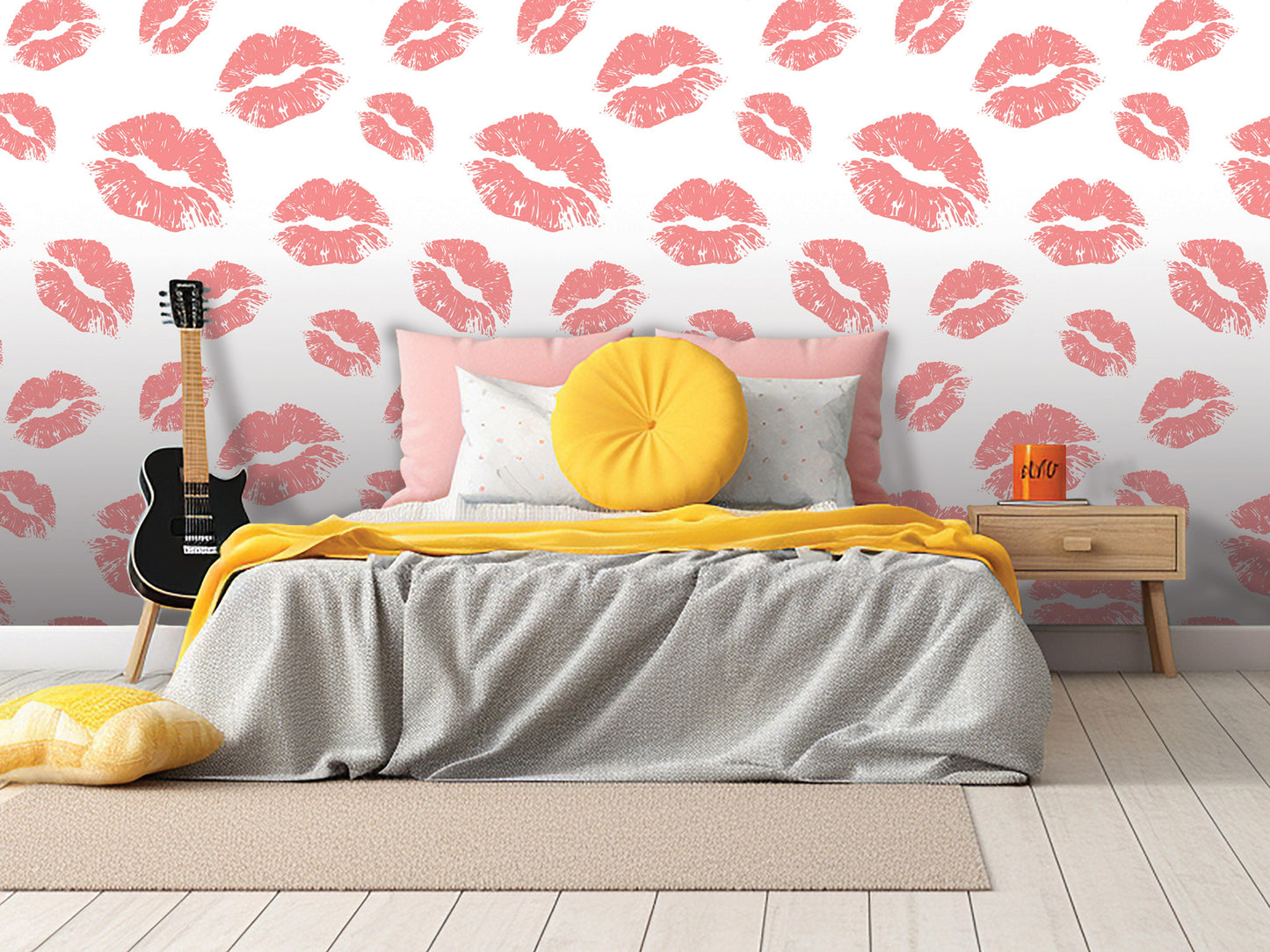 a bedroom with a bed, a guitar, and a yellow pillow. The walls are covered in a pattern of red lips, and the room has a wooden floor.